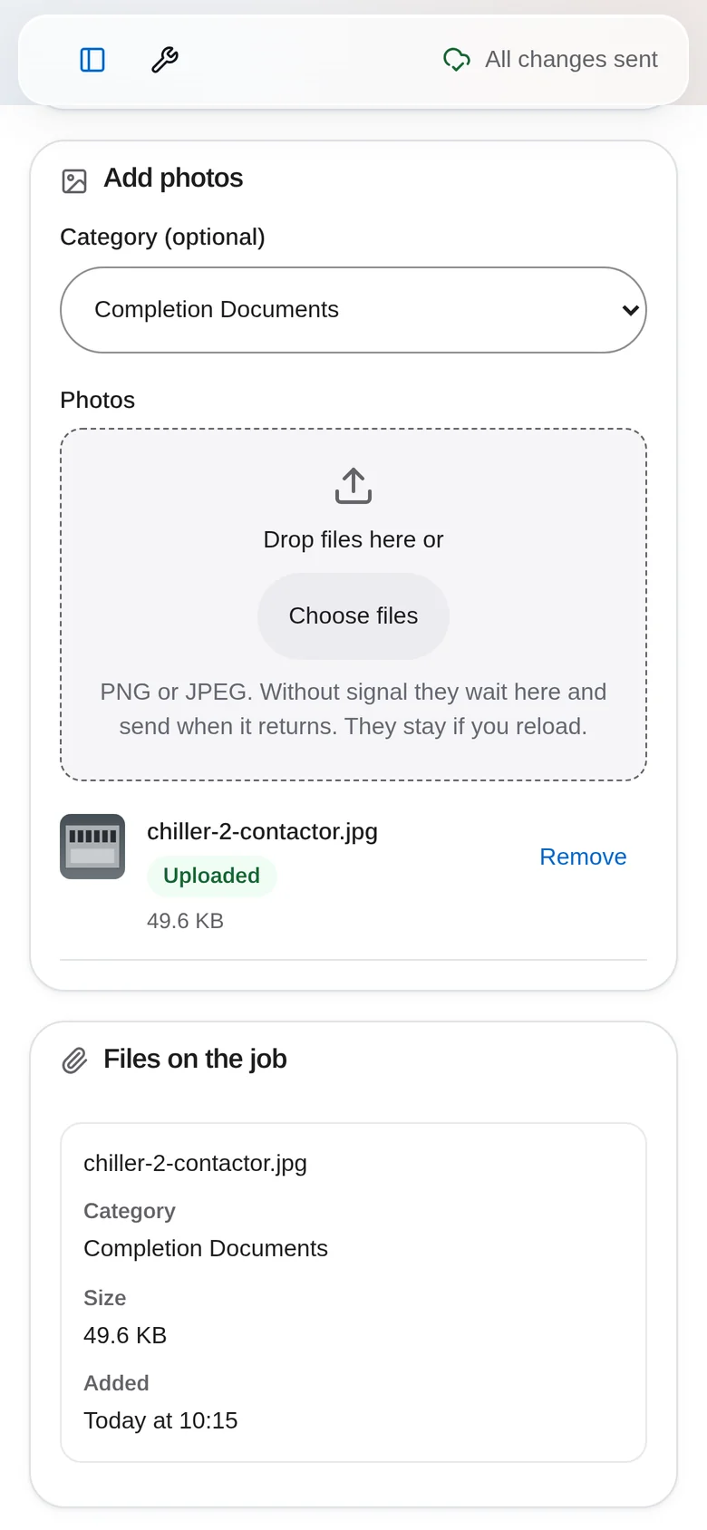 The job photo screen with a Completion Documents category, file upload area and an uploaded photo listed under Files on the job.